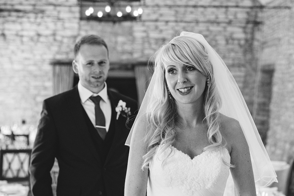 Black and white photo of bride and groom smiling