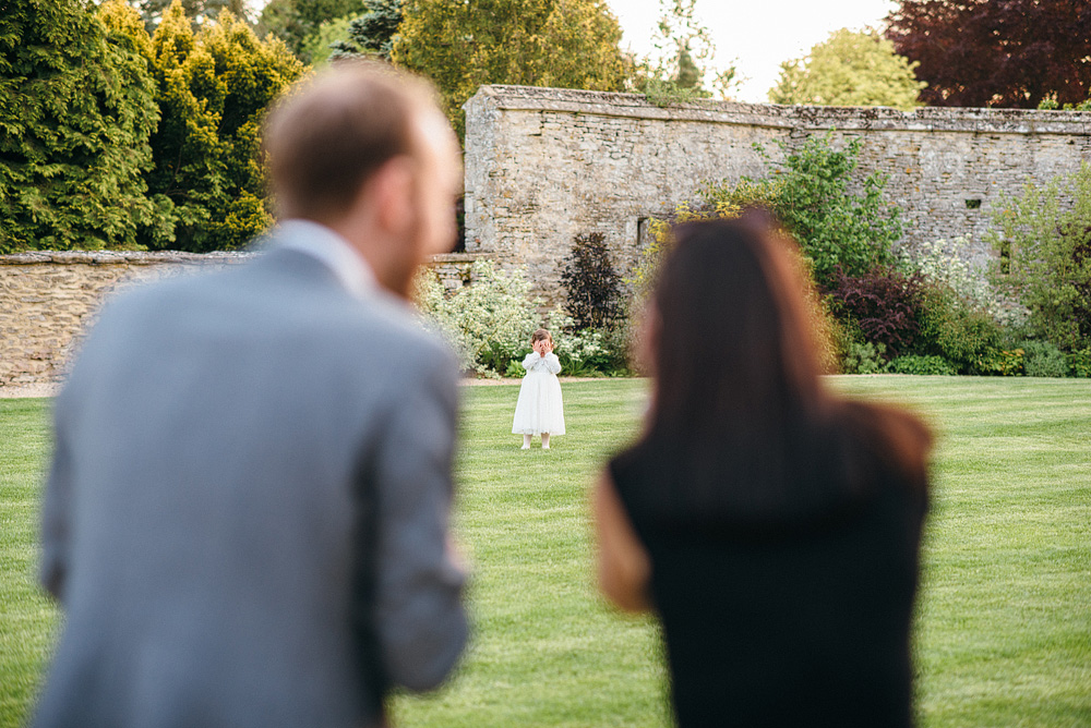 Caswel House Wedding Photography Two guests watching a child playing in grass