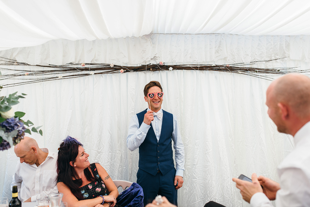 Bristol whimsical wedding. Groom hlding up funky glasses