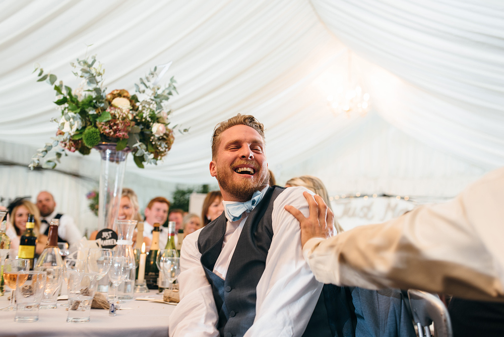 wedding guest laughing at reception