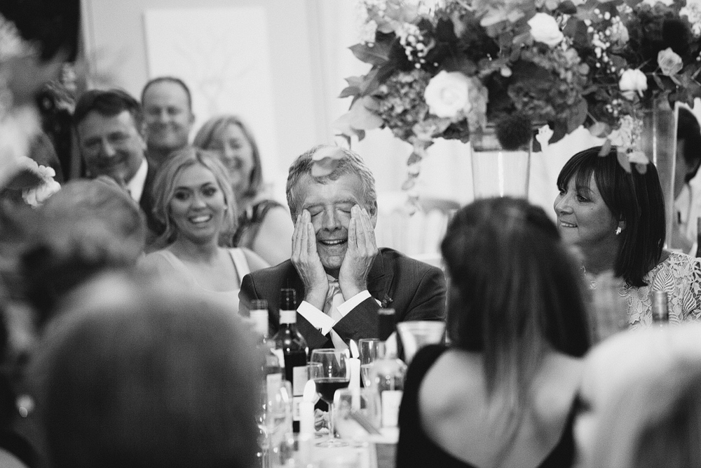father of the bride laughing at wedding speech