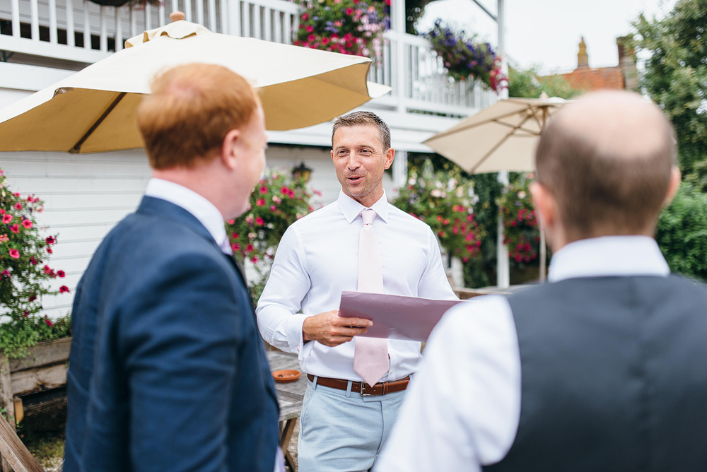Groom talking with guests outside