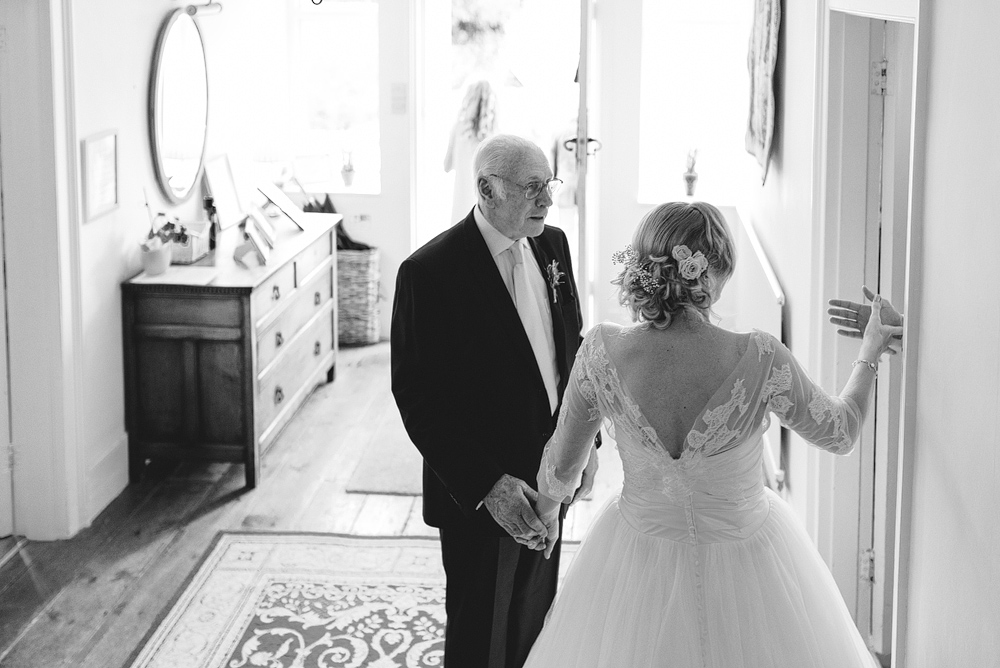 Bride and father holding hands