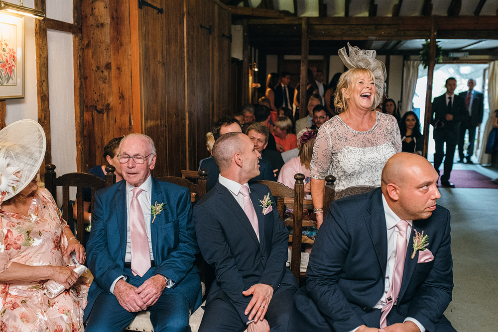 Wedding guests sitting and laughing at reception