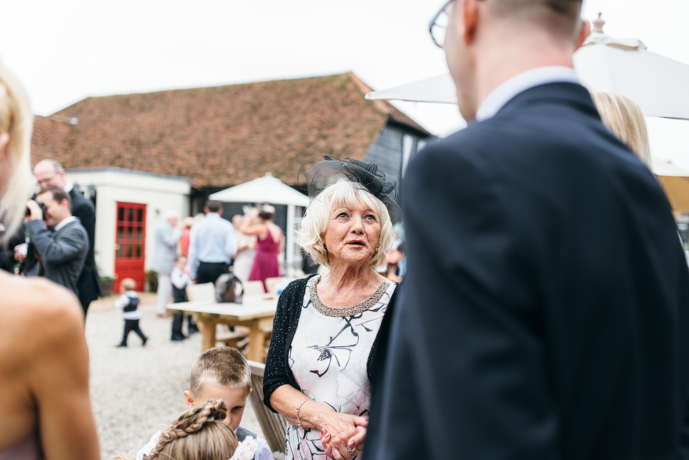 Woman talking with wedding guests outside