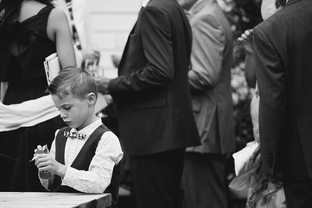 Small boy playing at table during wedding reception