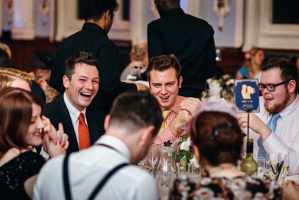 Table of wedding guests laughing together