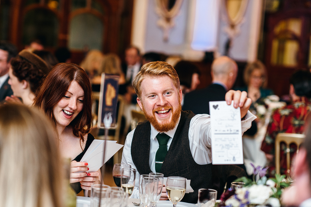 Guests smiling at table at wedding reception