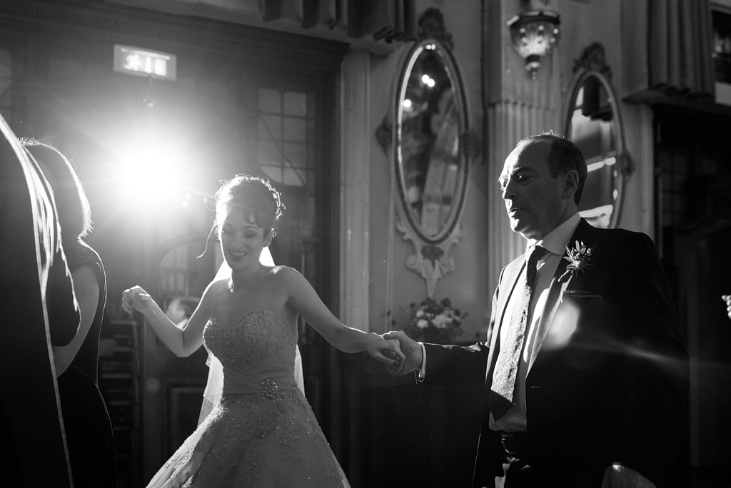 Bride dancing with man at wedding reception