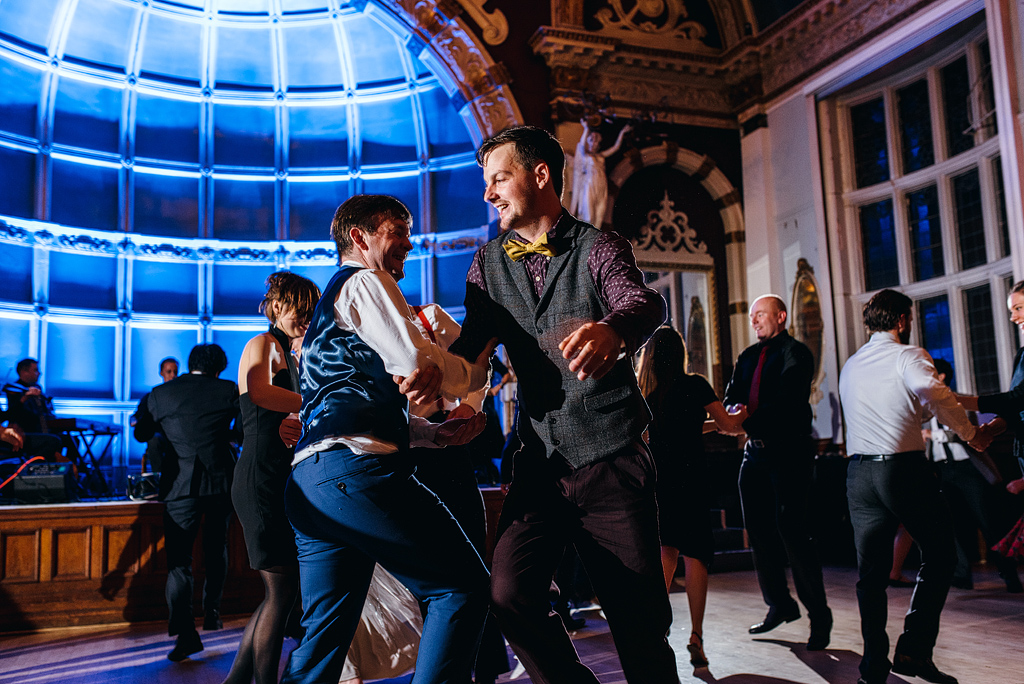 Two men dancing on wedding dance floor