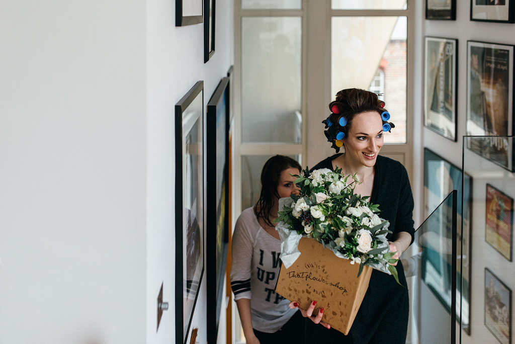 Bride walking up stairs with bouquets of flowers