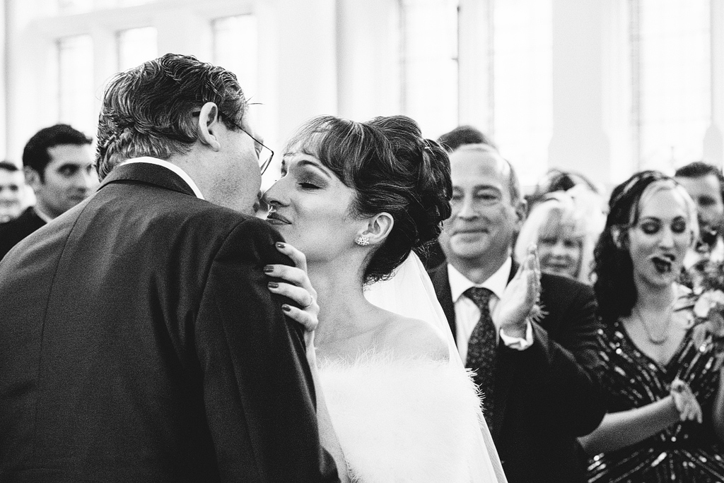 Bride and groom sharing first kiss
