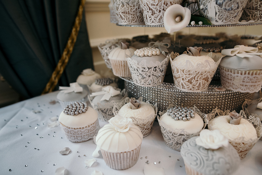 Beautiful lace cupcakes displayed at wedding reception