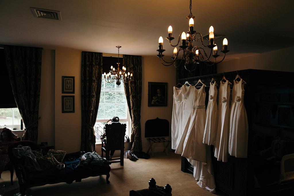 Bridal party dresses hanging in suite, awaiting wedding