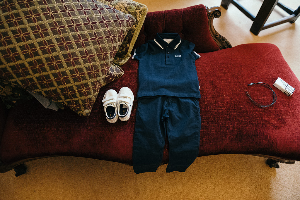 Small child's outfit laid out on chair for wedding