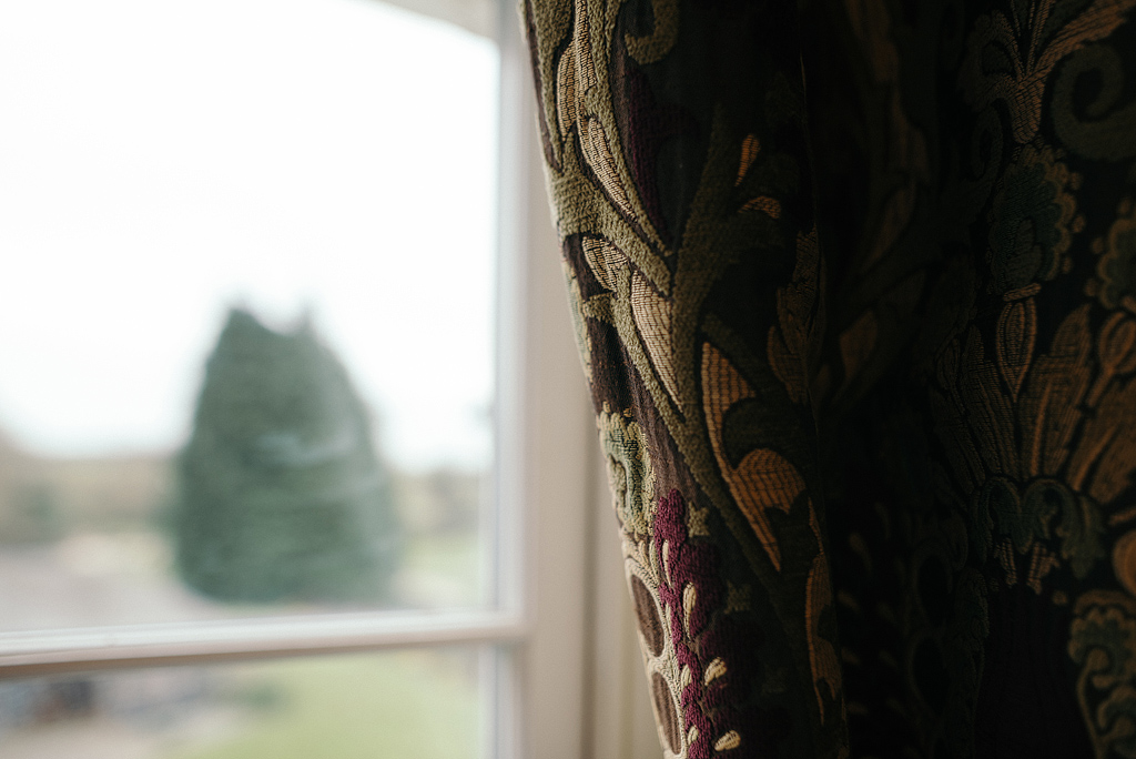 Curtains in bridal suite, light shining in through window