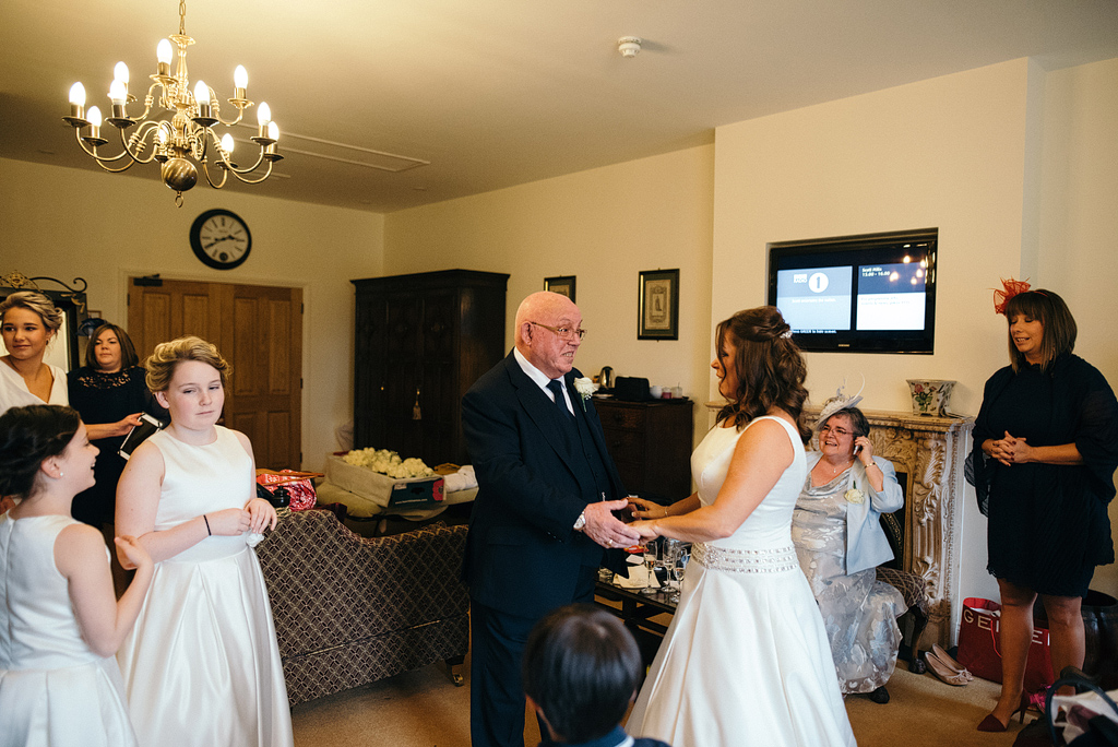 Happy father speaking to bride before wedding