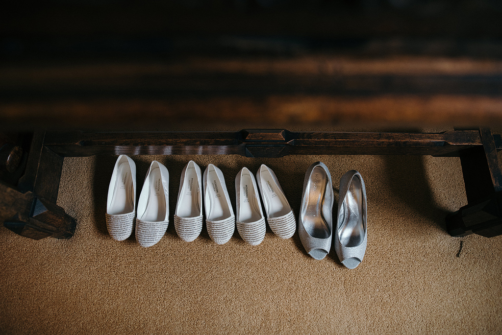 Row of bridesmaid shoes before wedding ceremony