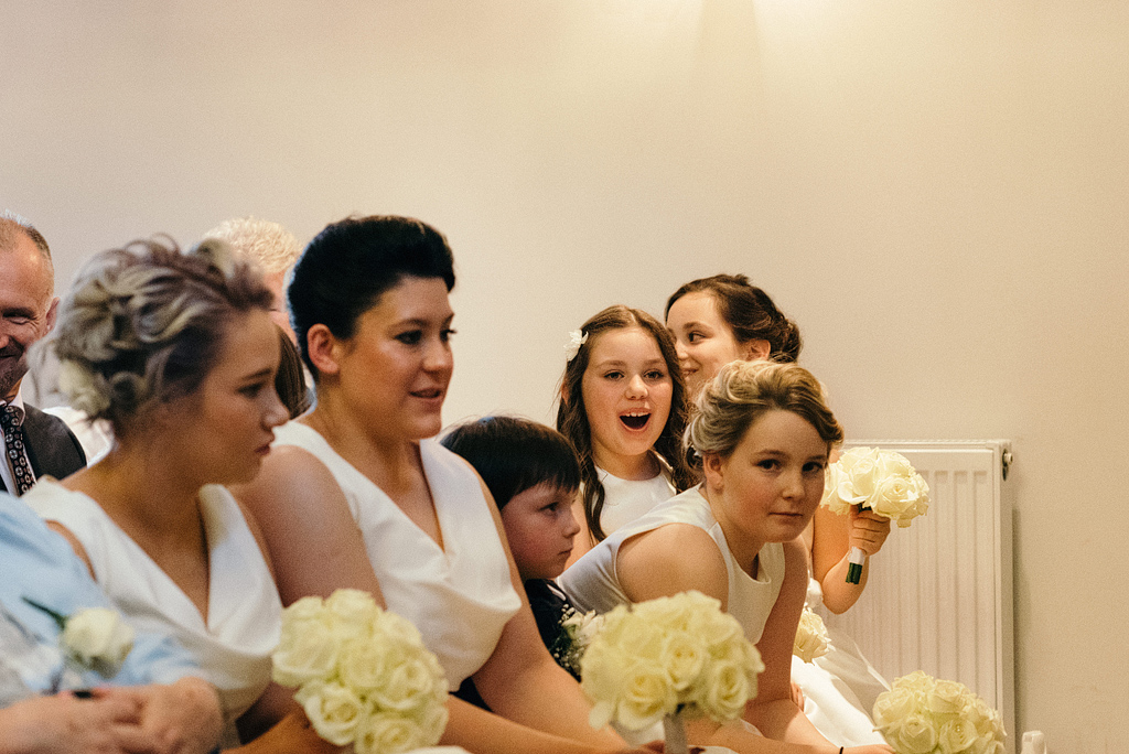 Bridal party smiling and laughing at wedding ceremony