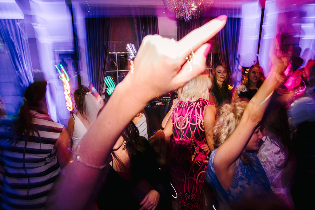 Women dancing waving arms at wedding reception