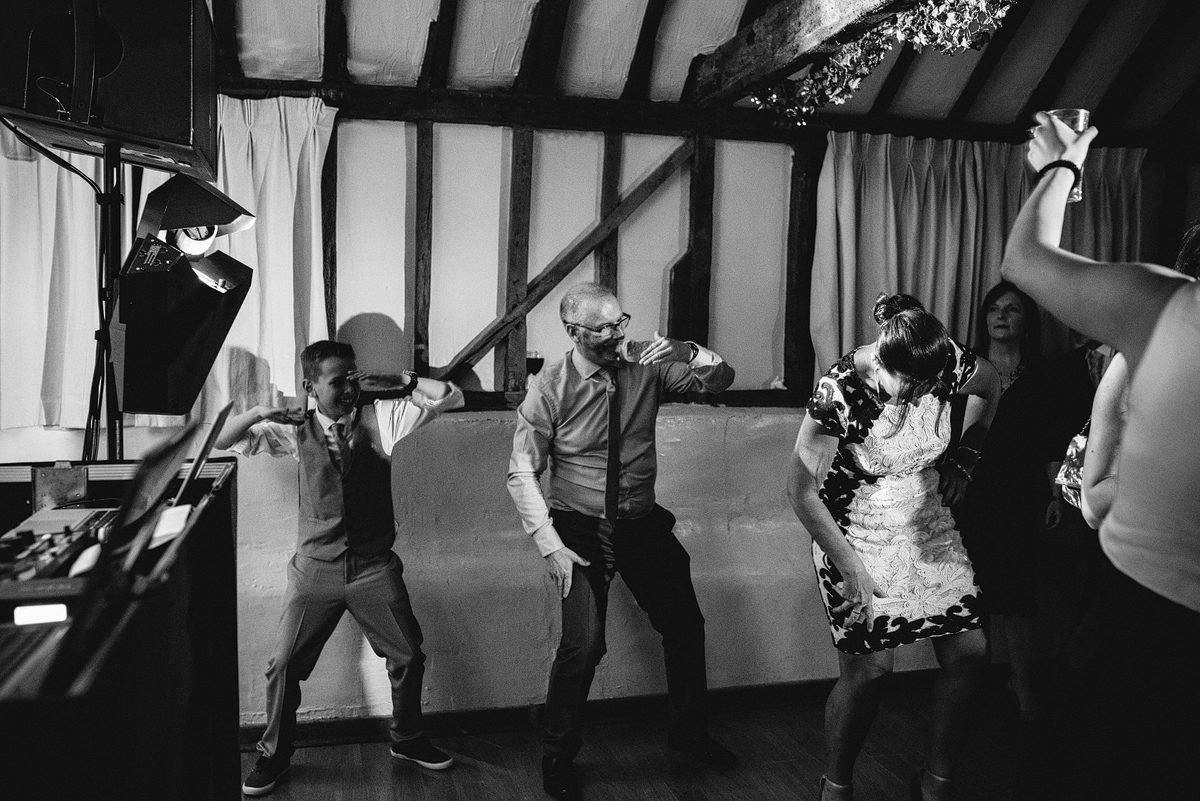 Black and white, guests dancing silly at wedding reception