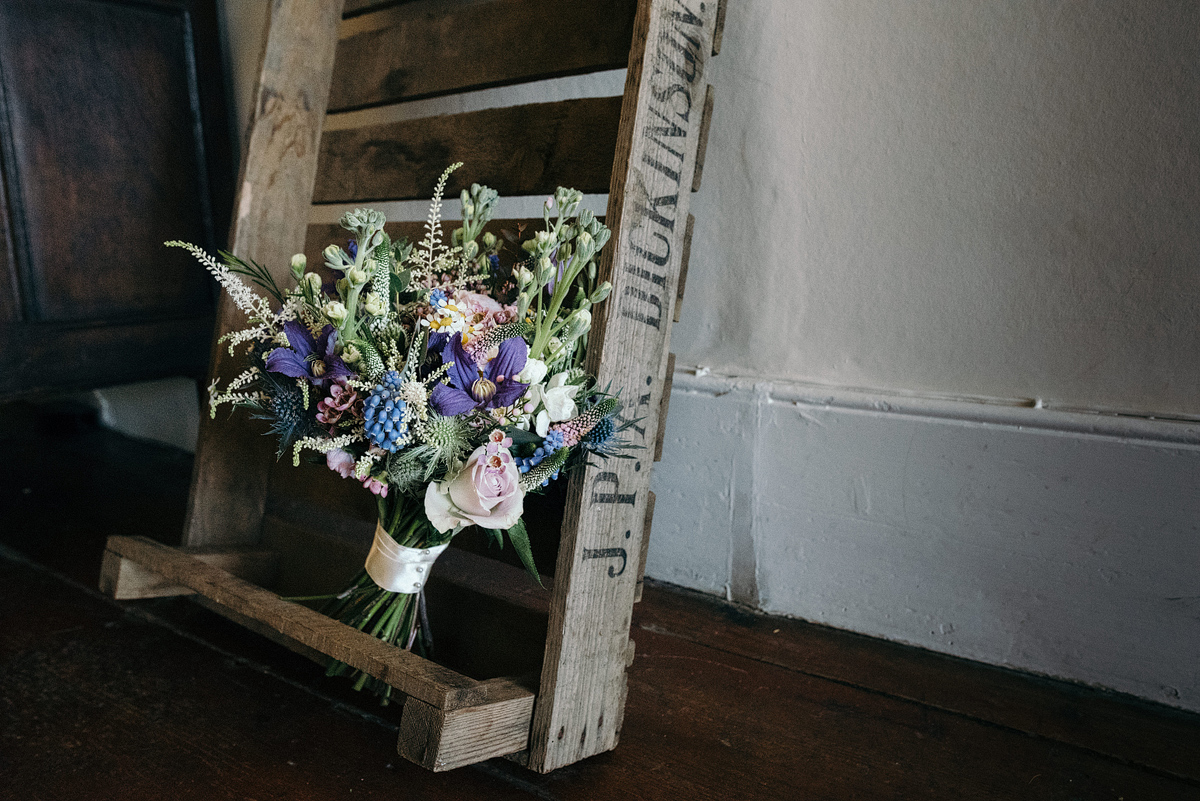 Bride's bouquet displayed on wooden crate. Rustic wedding ideas.