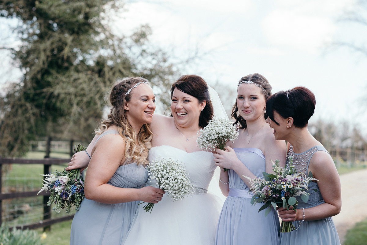 Bride laughing with bridal party outside