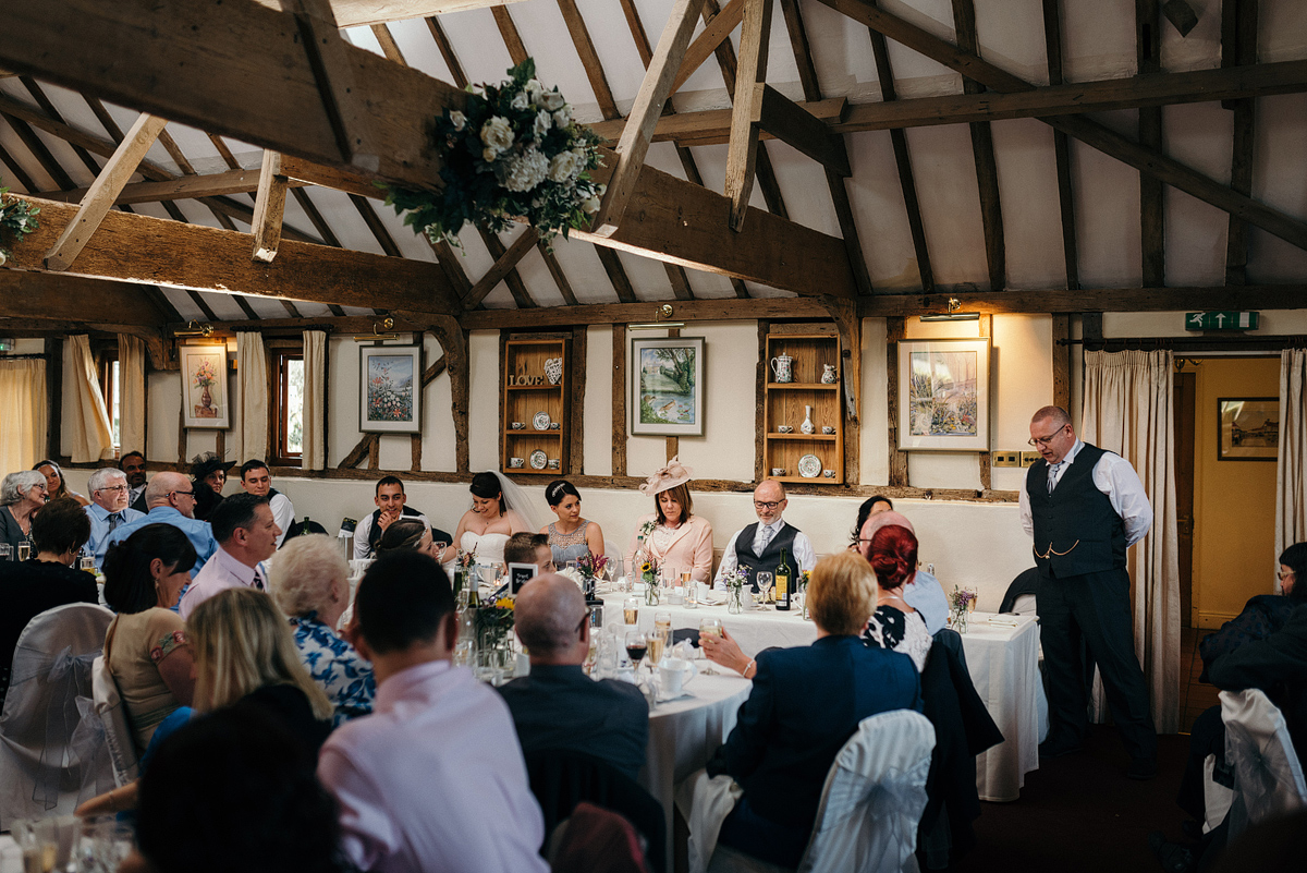 Father of bride standing giving toast at table