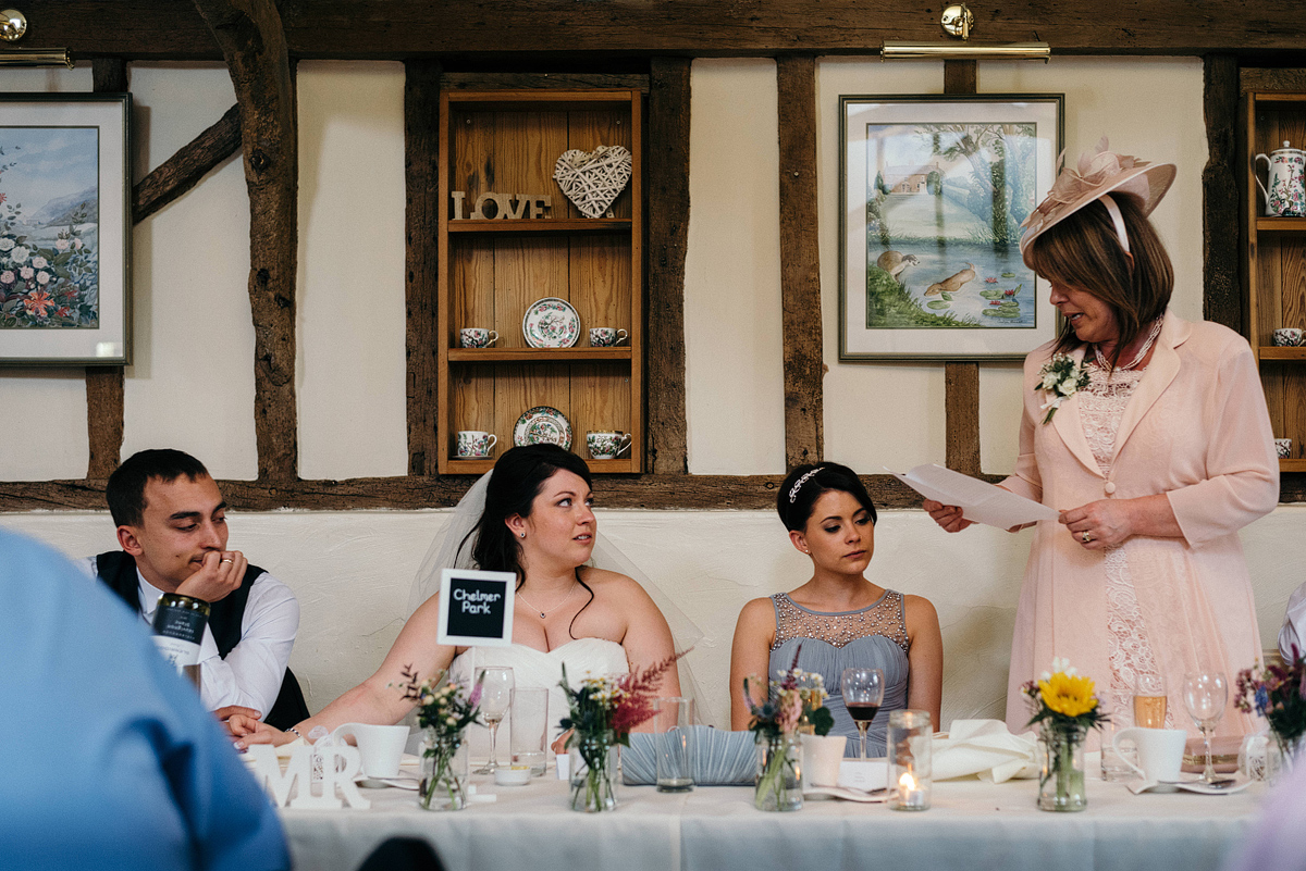 Mother of bride giving wedding speech at table