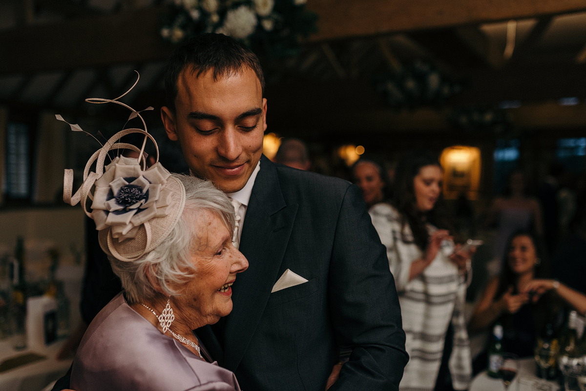 Groom and older woman smiling while dancing